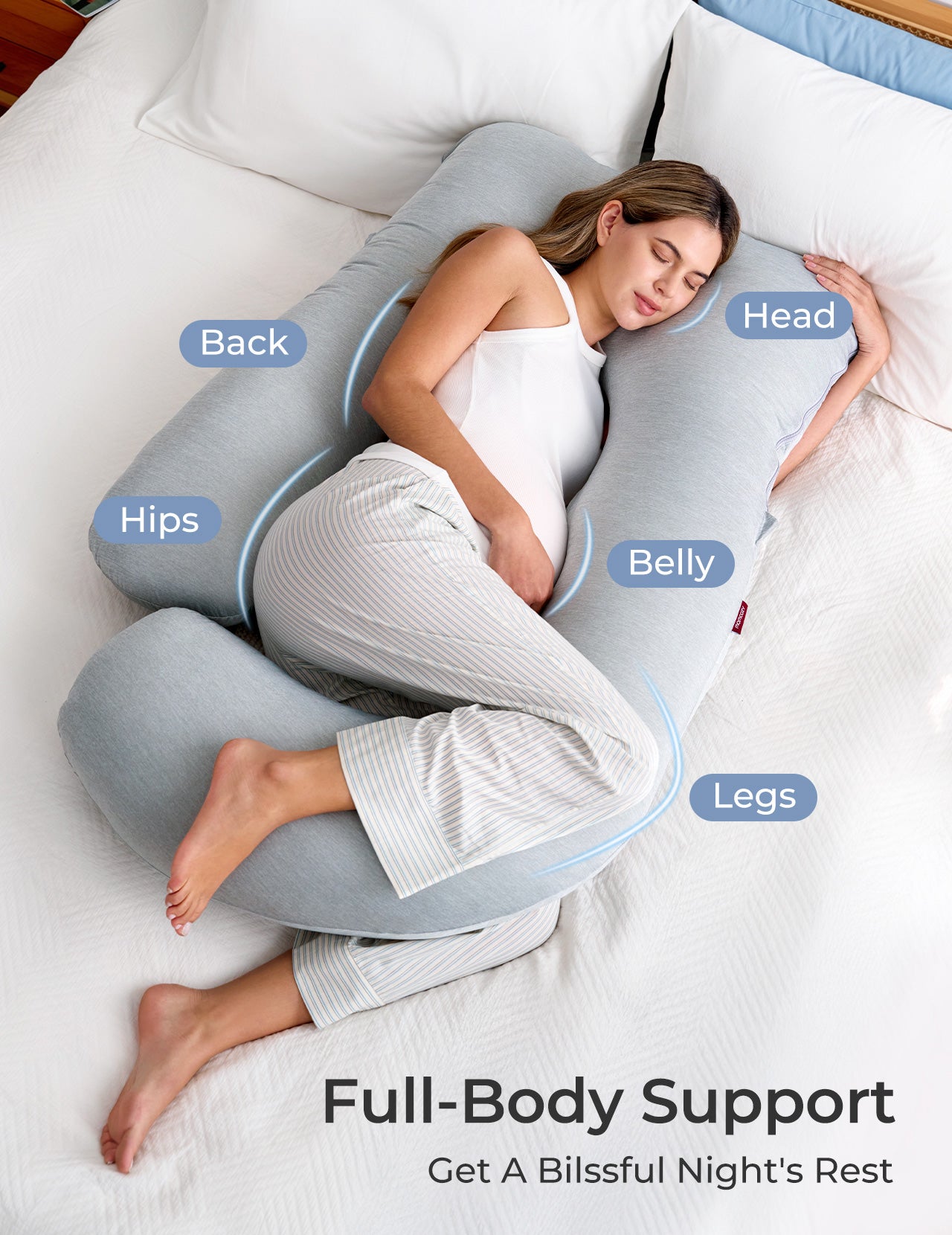 Pregnant woman resting on gray U-shaped maternity pillow, full body support for pregnancy, restful sleep, Momcozy
