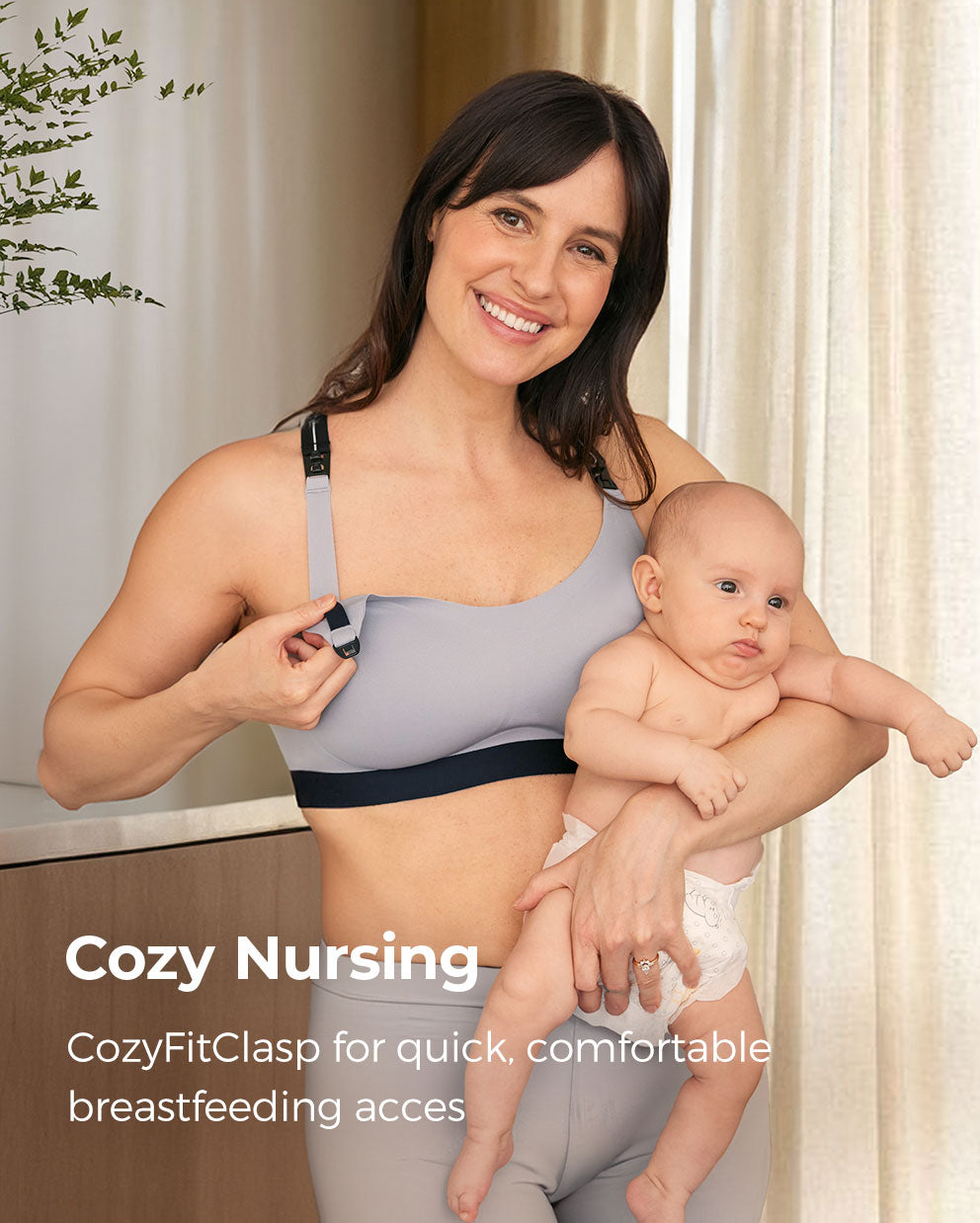 Nursing mother in gray bra, holding baby, demonstrating CozyFitClasp for easy breastfeeding.