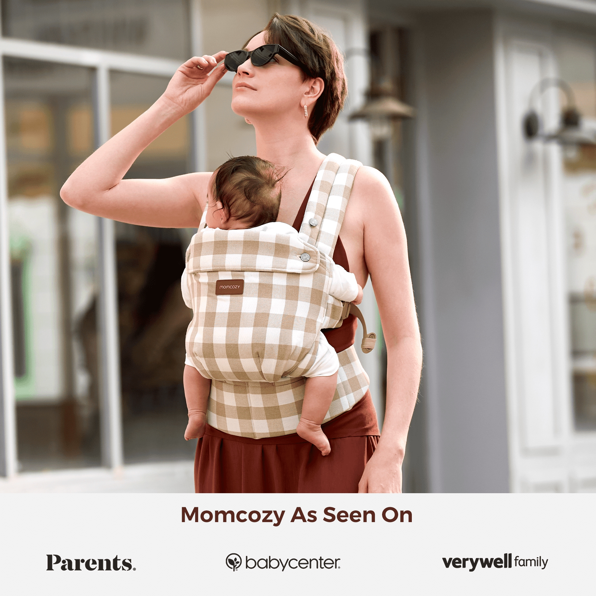 Momcozy PureHug baby carrier in a beige and white checkered pattern, as seen in Parents, BabyCenter, and Verywell Family.