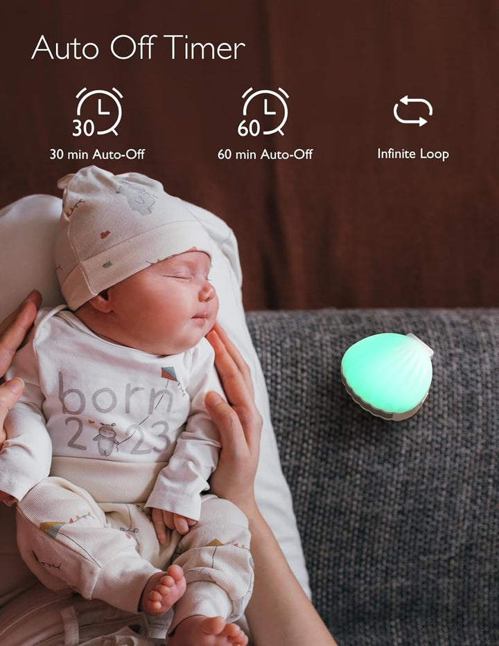 Baby sleeping peacefully with Momcozy Portable Sound Machine featuring auto-off timer.