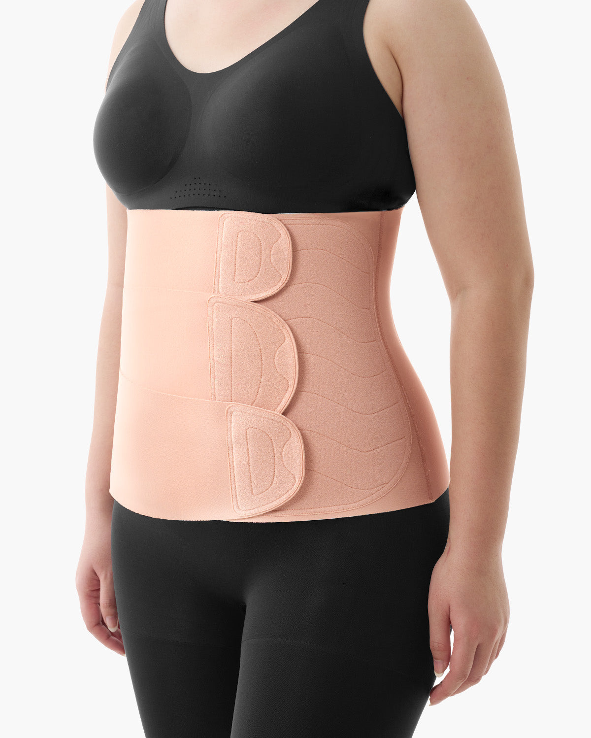 Momcozy Ergowrap Postpartum Belly Band in oyster pink color worn by a woman, with adjustable straps for postpartum support.