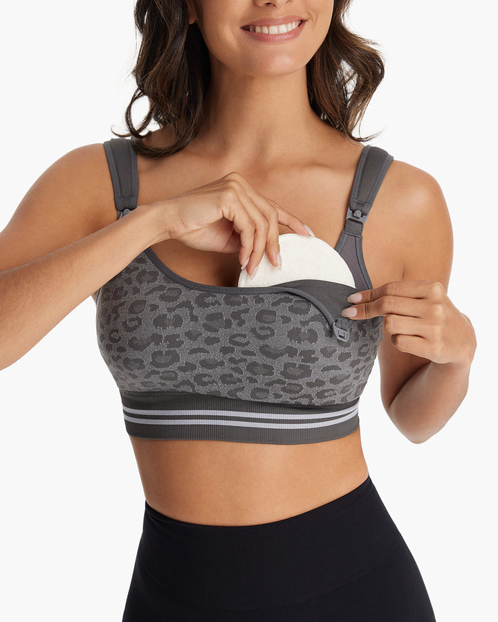 Woman adjusting grey leopard print HF022 4-in-1 hands-free seamless pumping bra, highlighting nursing access and comfort.