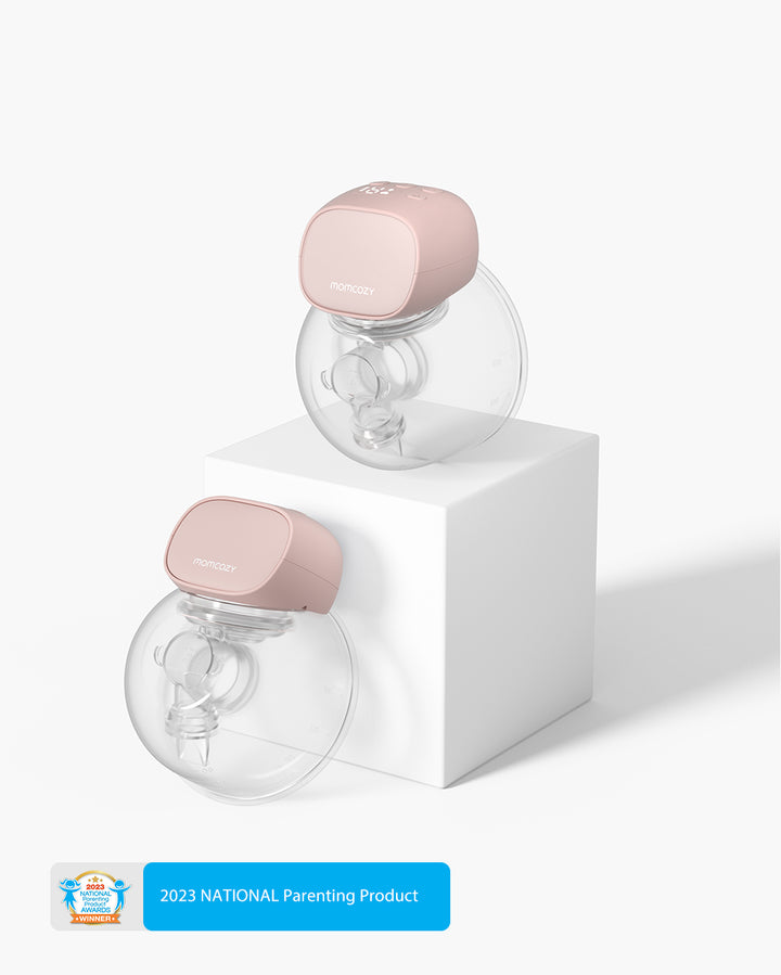 S9 Pro Wearable Breast Pump in soft pink with transparent milk collector on white pedestal.