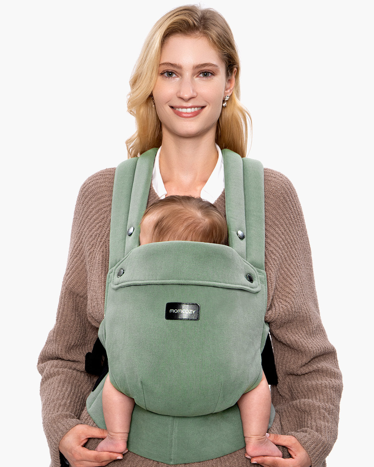 Momcozy PureHug baby carrier in sage green, babywearing comfortably. Mother and baby are smiling.