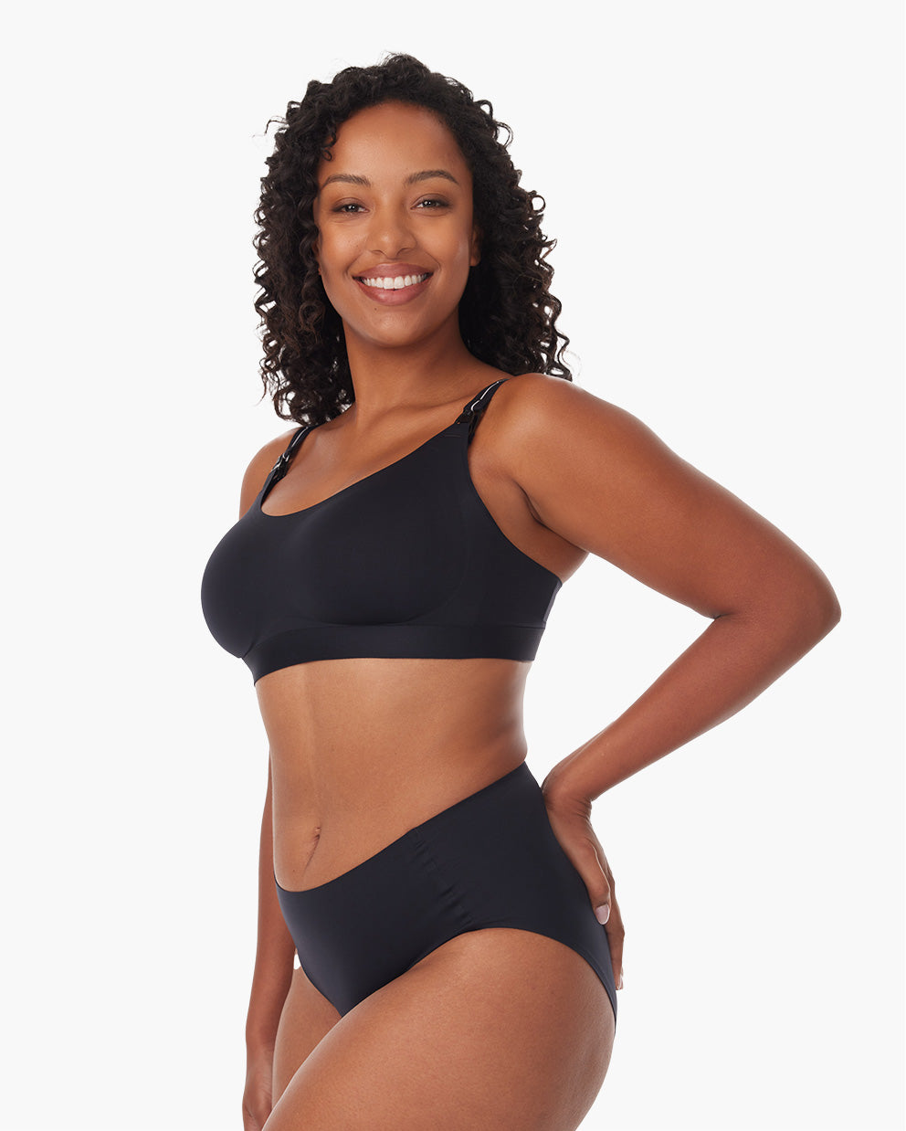 Black Momcozy nursing bra worn by a smiling woman, showcasing stylish design and comfort.